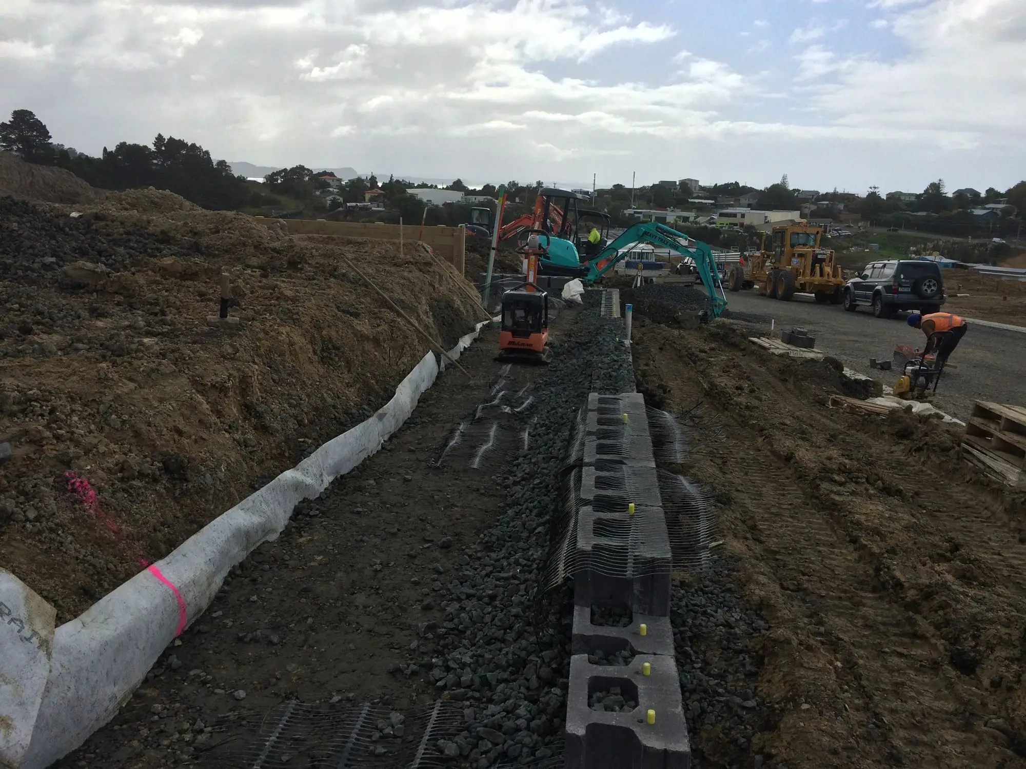 Segmental block retaining wall being built on a subdivision