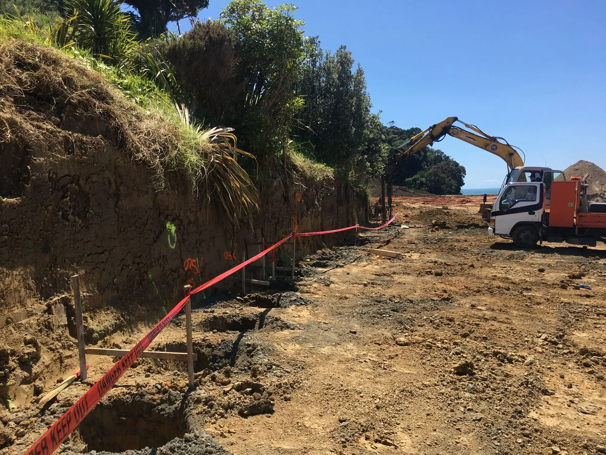 Excavator working on a sloping North Shore site